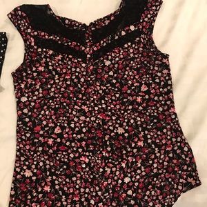 Pinkish colored blouse with flowers.